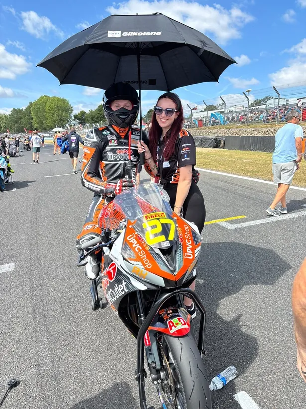 Calum on the grid under an umbrella before a race