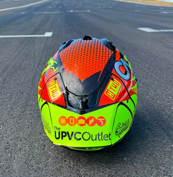 The back of Calum's helmet with the UPVC Outlet logo