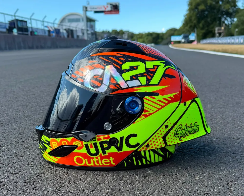 Calum's Shark helmet from the side, fluoro yellow and red with the CAL27 mark